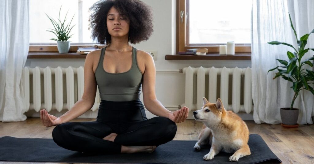 spiritual practice woman meditating with dog